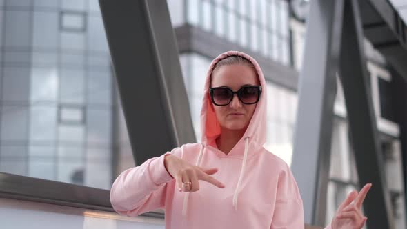 A Girl in a Pink Jacket is Dancing Hip Hop She is Wearing Sunglasses