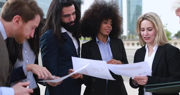 Multiracial business people working outdoor from office building