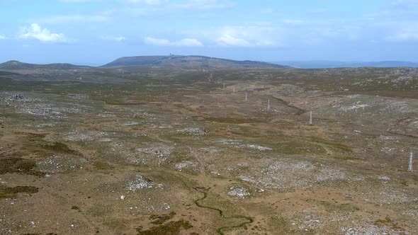 Aerial Flying Over Large Sierra Plain In Galicia With Row Of Wind Turbines In Landscape. Dolly Forwa