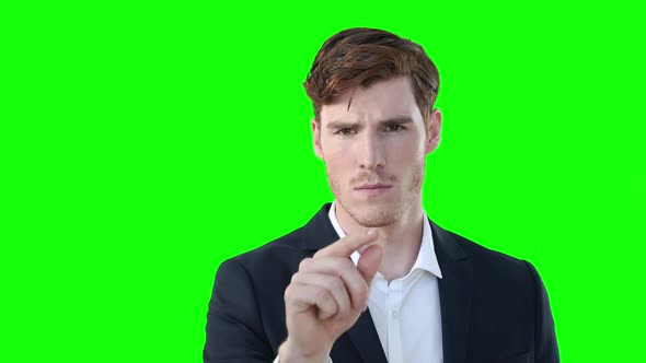 Caucasian man raising hand on green background