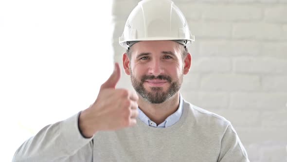Portrait of Positive Young Engineer Doing Thumbs Up