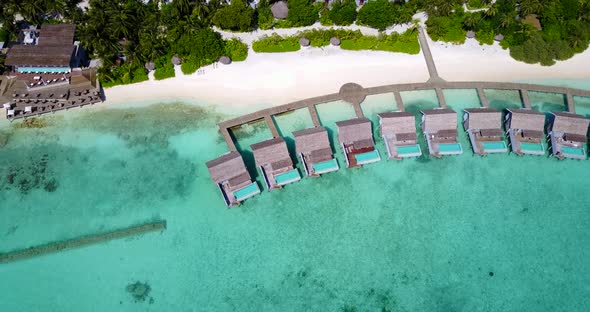 Tropical overhead tourism shot of a summer white paradise sand beach and aqua blue water background 