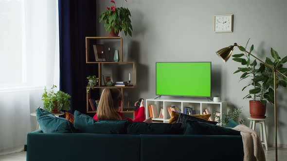 Woman Watching Television with Green Screen