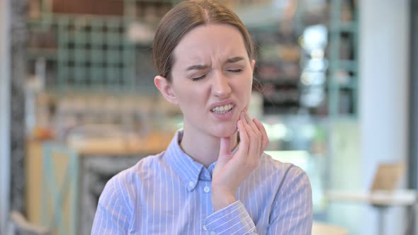 Portrait of Young Businesswoman with Toothache