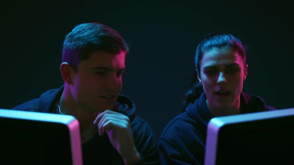 Man and woman working on computers