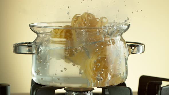 Super Slow Motion Shot of Fresh Pappardelle Falling Into Boiling Salted Water at 1000 Fps