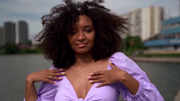 Happy Young Afro-american Woman Is Dancing Joyfully in Cityscape at Summer Day
