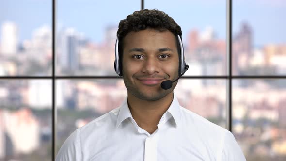 Smiling Call Center Operator on Windows Background