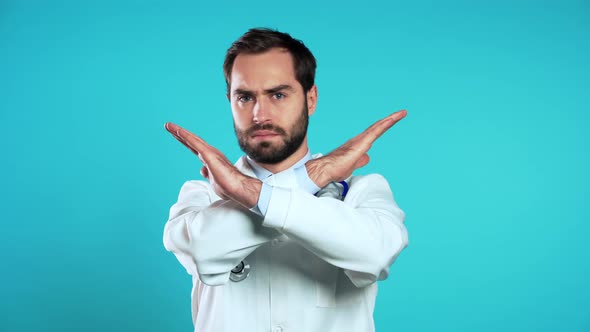 Portrait of Doctor in Medical Coat with No Crossing Hands Sign Negation Gesture