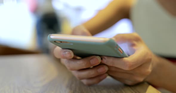 Woman typing on mobile phone at outdoor 