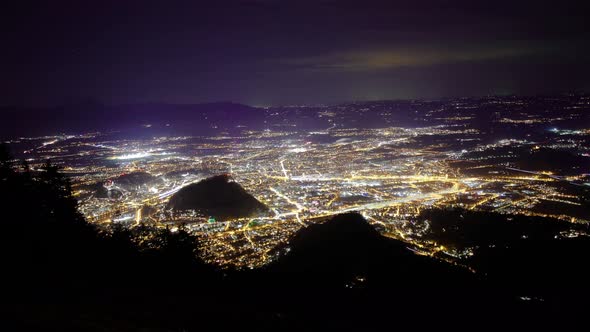 Timelapse at Night from an Mountain with view to the City, Clouds and Fog