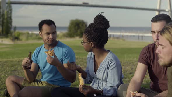 Side View of Serious Friends Having Picnic in Park