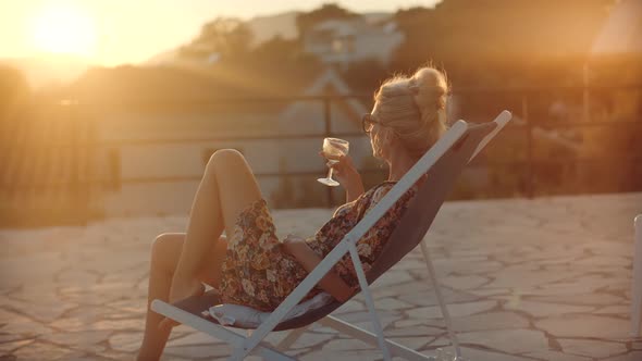 Woman Drinking White Wine Holidays Vacation.Romantic Evening Enjoying Wineglass.