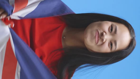 Young Woman Wrapped in and Dancing with Union Jack