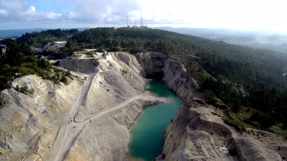 View Of Green Toxic Lake At Monte Neme Abandoned Mine. Aerial Dolly Back