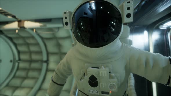 Astronaut Inside the Orbital Space Station alt