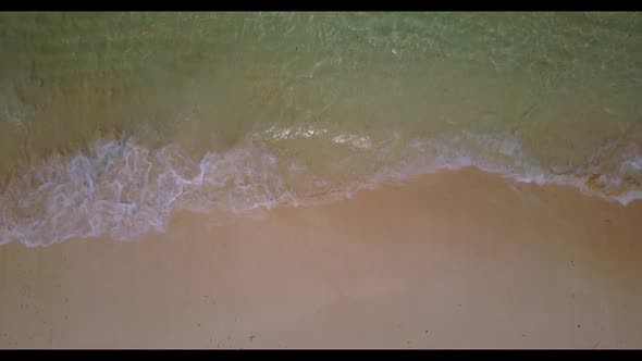 Aerial drone shot seascape of luxury sea view beach trip by shallow lagoon with white sandy backgrou