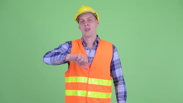 Angry Young Man Construction Worker Giving Thumbs Down