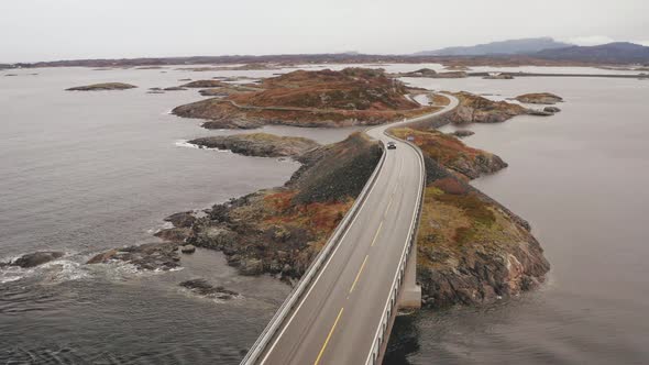 Car Crossing Magnificent Storseisundet Bridge On Atlantic Ocean Road, Norway. - Aerial Orbit, zoom i