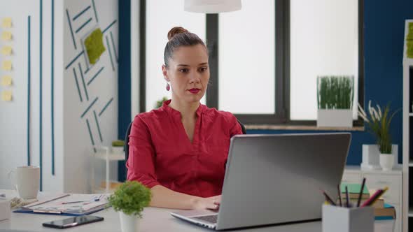 Portrait of Business Woman Working with Sales Charts on Laptop