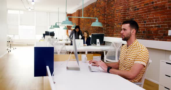 Male executive working on computer at desk