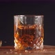 Whiskey glass with ice cube splash in slow motion - VideoHive Item for Sale