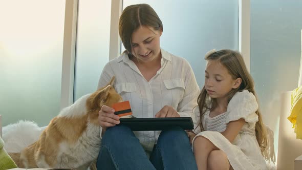 Mother With Her Daughter Spending Money Together