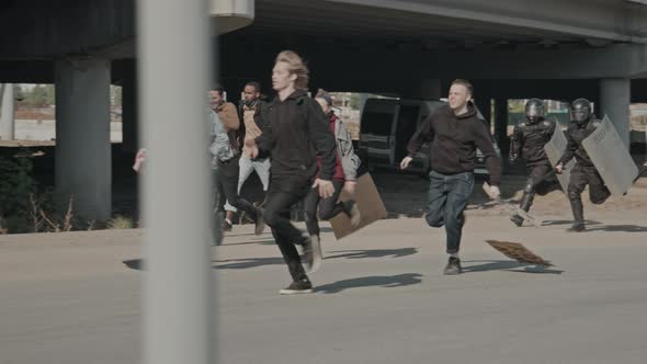 Riot Police Running After Activists with Signs