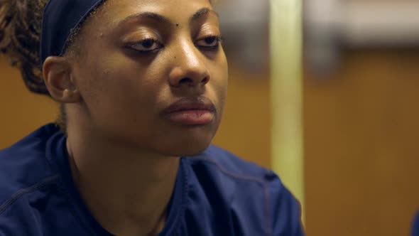 An african american woman listens to a lecture