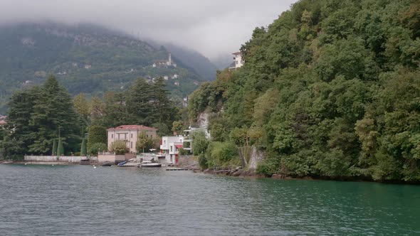 Sailing Past a Village on Lake Como on a Cloudy Day