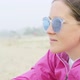 The Girl Sits on the Beach and Looks at the Water - VideoHive Item for Sale