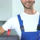 Friendly smiling workman holding box with tools and smiling to camera - VideoHive Item for Sale