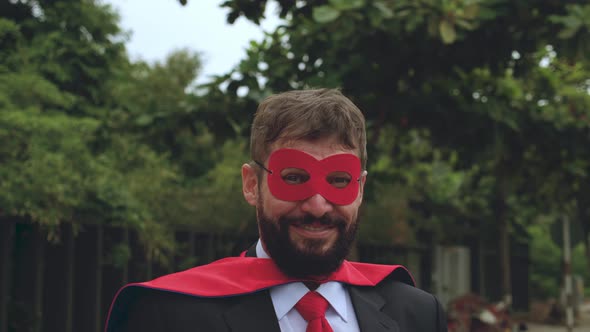 Portrait of a Positive Smiling Bearded Professional Businessman of Senior Man in a Red Raincoat and