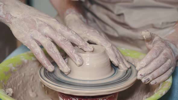 Closeup View of Woman and Man Hands Making Ceramic Pot or Sculpting Clay