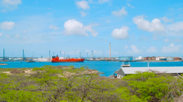 Pan of red oil tanker laying in harbor of oil refinery ISLA, Curacao.