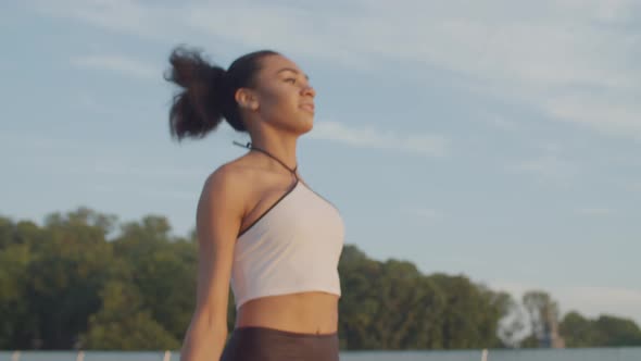 Sporty Fit Woman Working Out with Jump Rope at Dawn