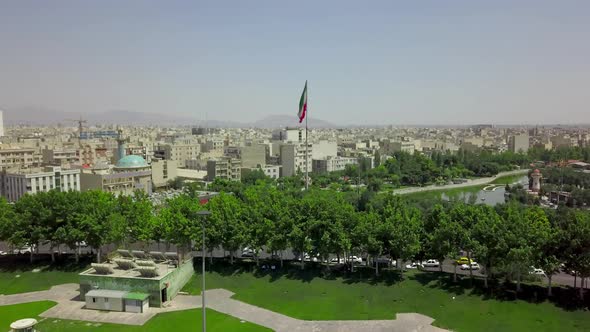 Aerial drone view of the city near Azadi tower in Tehran.View of waving Iranian flag.Iran 2018,may