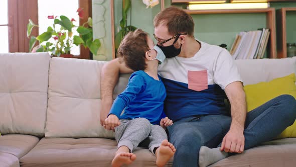 In Front of the Camera Small Boy with His Dad Stay