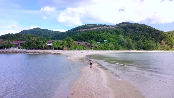 Young Pretty Woman in Black Swimsuit Running Alone on a SandbarThailand