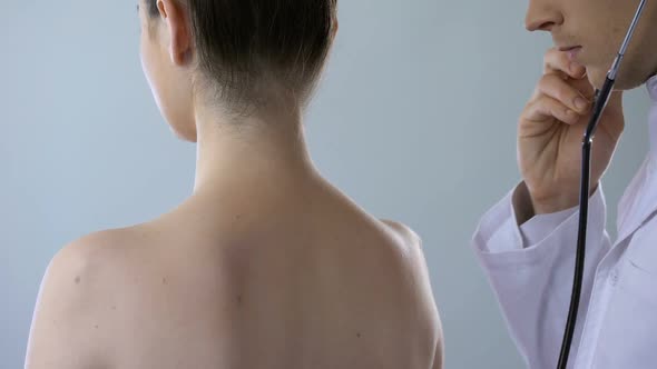 Woman Coughing Hard, Physician Listening to Her Lungs, Treatment of Pneumonia