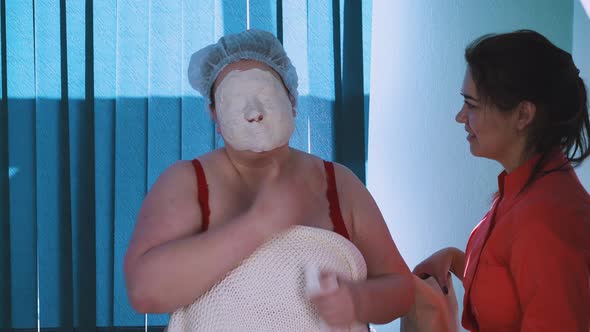 Woman with Overweight and Alginate Mask and Cosmetologist
