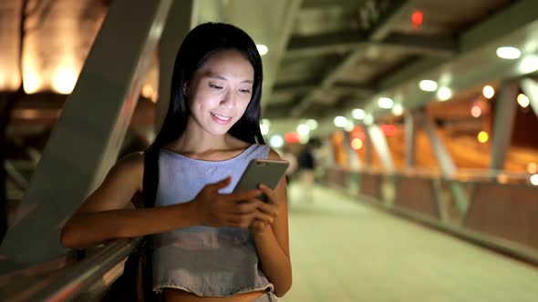 Woman Looking at Mobile Phone at Night 