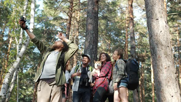 Slow Motion of Happy Young People Hikers Taking Selfie in Forest Posing for Camera Having Fun