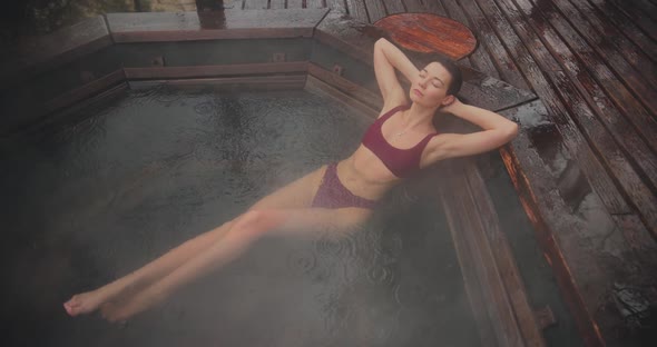 Woman in Bikini Bathing in Japanese Style Bath Outdoors