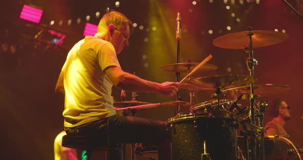 Back View of Drummer Playing Drums at the Stage on Live Concert