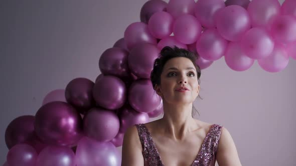 Young Girl in Purple Dress Throws Confetti Up