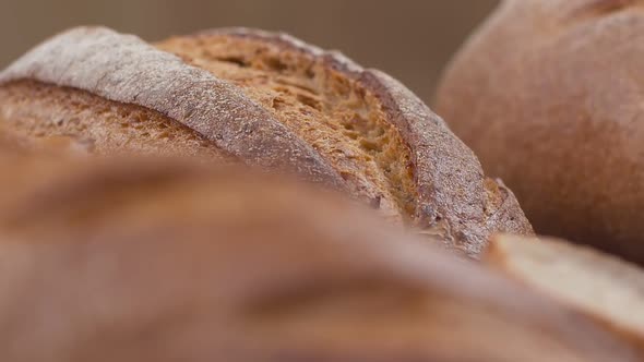 Camera is Zoom Through Sliced and Whole Wheat Bread and Wheat Ears to the Clay Pots