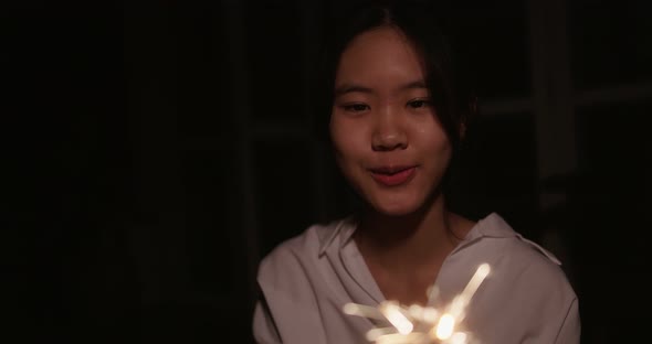 Close Up Sparklers Portrait Of Lovely Asian Girl Celebrating Chinese New Years. Slow Motion Shot.