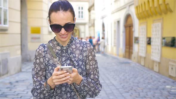 Woman Walking in City. Young Attractive Tourist Outdoors in European City