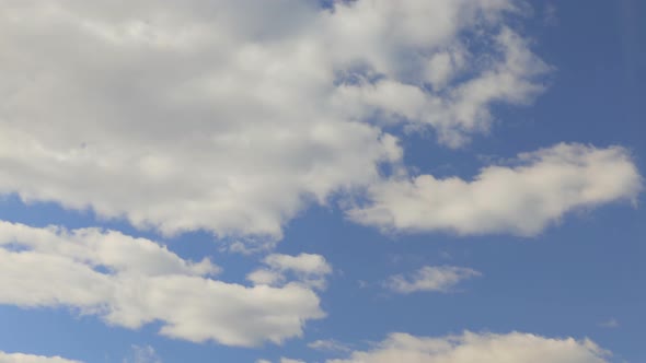 White Clouds Move Across a Beautiful Blue Sky. Nice Sunny Weather.